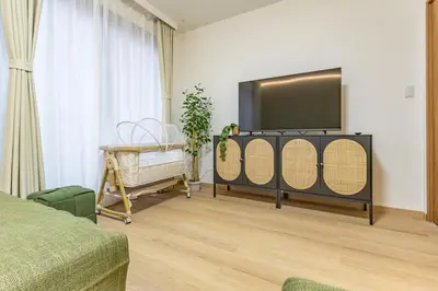 a living room with a flat screen tv on a stand at KOKORO INN TOKYO 5-minute walk to Senso-ji Temple Four-story private house with two bathrooms luxury stay in Tokyo