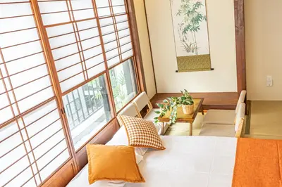 a bedroom with a bed and a large window at KOKORO INN TOKYO 5-minute walk to Senso-ji Temple Four-story private house with two bathrooms luxury stay in Tokyo