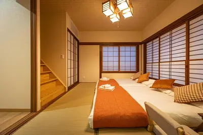 a bedroom with a large bed in a room with windows at KOKORO INN TOKYO 5-minute walk to Senso-ji Temple Four-story private house with two bathrooms luxury stay in Tokyo
