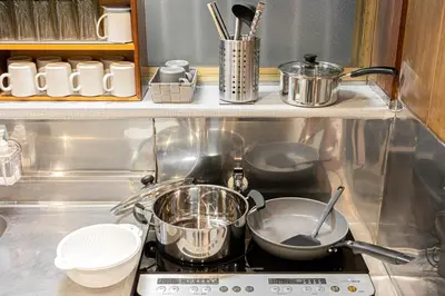 a stove with pots and pans on top of it at Soresta INN \u7be0\u5d0e in Tokyo