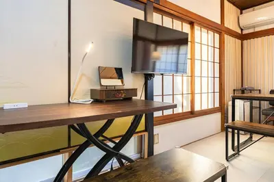 a room with a desk with a tv and a table at Soresta INN \u7be0\u5d0e in Tokyo