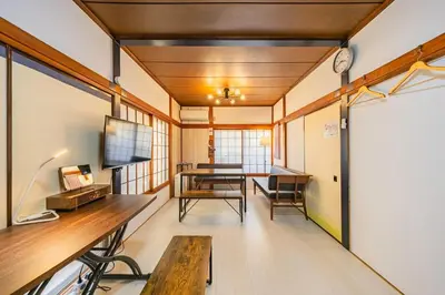 a room with a desk and a table with a bench at Soresta INN \u7be0\u5d0e in Tokyo
