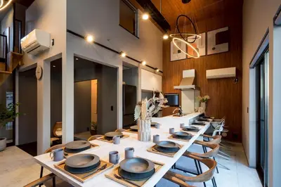 a long dining room with a long table and chairs at Camo's Tokyo Asakusa in Tokyo