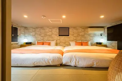two beds in a hotel room with two beds sidx sidx sidx at Camo's Tokyo Asakusa in Tokyo