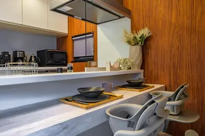 a kitchen with two bowls on a counter with two chairs at Camo's Tokyo Asakusa in Tokyo