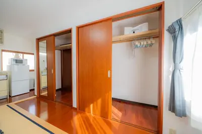 a wooden door in a room with a kitchen at SYLA HOTEL Akasaka in Tokyo