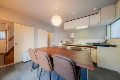 a kitchen with a wooden table and chairs at SYLA HOTEL Akasaka in Tokyo