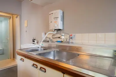a kitchen with a stainless steel sink and aounter at SYLA HOTEL Akasaka in Tokyo