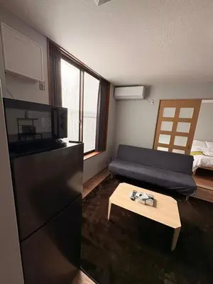 a kitchen with a couch and a table in a room at \u30a2\u30e0\u30db\u30fc\u30e0 in Tokyo