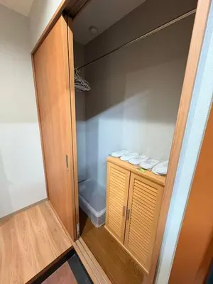 a walk in closet with a wooden cabinet and towels at \u30a2\u30e0\u30db\u30fc\u30e0 in Tokyo