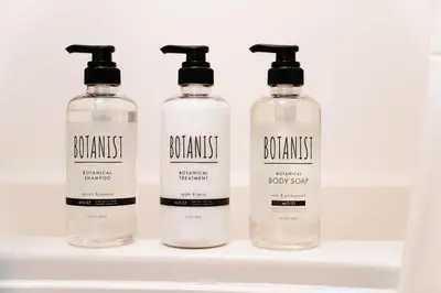 four bottles of shampoo and conditioner sit on a shelf at Promotion Asakusa , 1 room, 8 mins to ST Max 2P \u8d85\u9ad8\u6027\u4ef7\u6bd4 \u6d45\u8349\u5168\u65b0\u88c5\u4fee \u8f66\u7ad98\u5206\u949f \u6700\u59272\u4eba in Tokyo