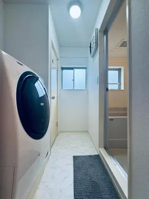 a hallway with a door with a television on the wall at Kitashinjuku 2DK-2F-B in Tokyo