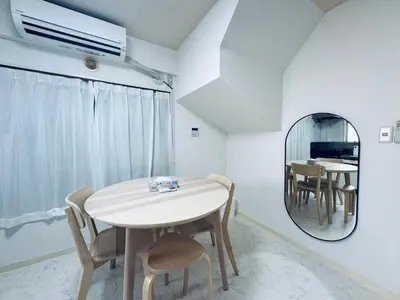a dining room with a table and a mirror at Kitashinjuku 2DK-2F-B in Tokyo