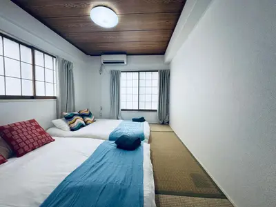 two beds in a room with two windows at Kitashinjuku 2DK-2F-B in Tokyo