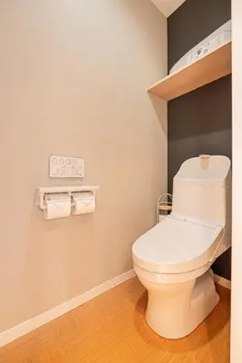 a bathroom with a toilet and a clock on the wall at Asakusa Miyabi Inn 2F in Tokyo