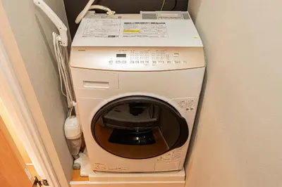 a washer and dryer in a corner of a room at Asakusa Miyabi Inn 2F in Tokyo
