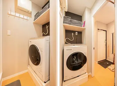 a laundry room with a washer and dryer at Asakusa Miyabi Inn 1F in Tokyo