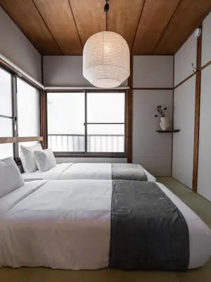 two beds in a room with two windows at HAN'S EBISU Hanare - Shibuya - Entire Renovated House in Tokyo