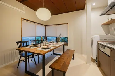 a dining room with a wooden table and chairs at HAN'S EBISU Hanare - Shibuya - Entire Renovated House in Tokyo