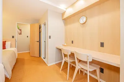 a bedroom with a desk and a clock on a wall at Komorebi Asakusa 202 Cozy 6P Stay The 77 House Tokyo in Tokyo