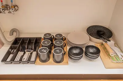 a kitchen counter with a tray of utensils and plates at Komorebi Asakusa 202 Cozy 6P Stay The 77 House Tokyo in Tokyo
