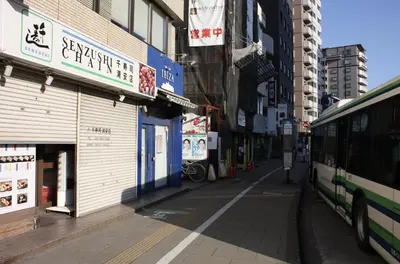 a bus is parked on the side of a street at Jasnine House in Tokyo