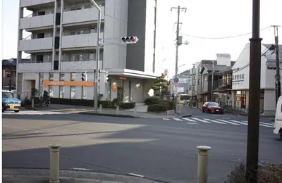 an empty city street with a traffic light and buildings at Jasnine House in Tokyo