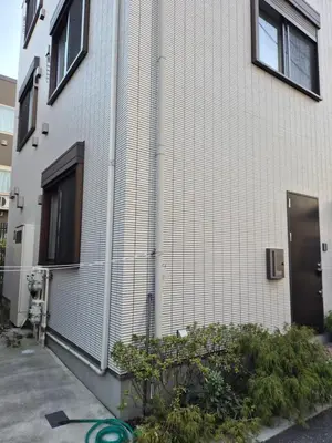 a building with a lot of plants in front of it at Jasnine House in Tokyo