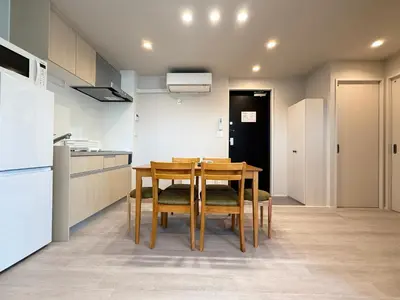 a kitchen with a wooden table and chairs in a room at PRISM Inn Ikegami Kamata in Tokyo