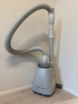 a vacuum sitting on the floor next to a wall at PRISM Inn Ikegami Kamata in Tokyo