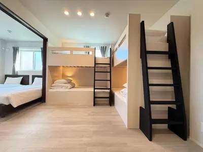 a small room with bunk beds and a ladder at PRISM Inn Ikegami Kamata in Tokyo