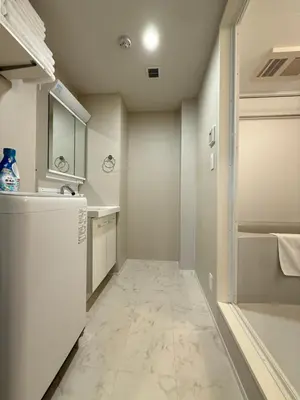 a kitchen with a white refrigerator and a tile floor at PRISM Inn Ikegami Kamata in Tokyo