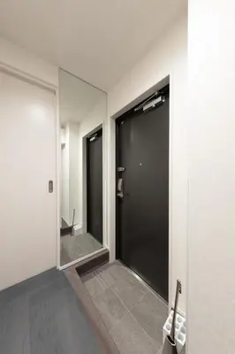 a hallway with two doors and a mirror at Hotel Kototoi East in Tokyo