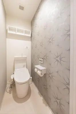 a bathroom with a toilet and a wall at Hotel Kototoi East in Tokyo