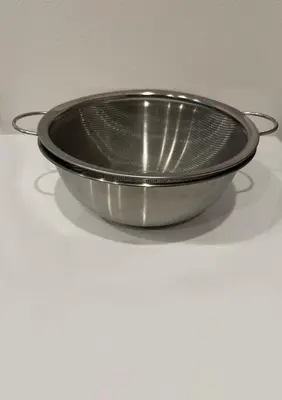 a metal bowl sitting on a white table at \u8535 The KURA in Urayasu