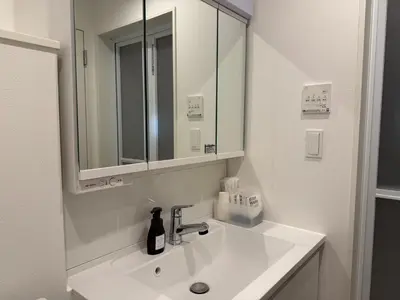a white bathroom with a sink and a mirror at \u8535 The KURA in Urayasu