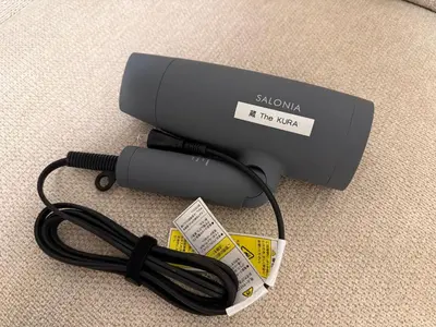 a hair dryer with a cord on the floor at \u8535 The KURA in Urayasu