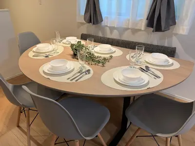 a dining room table with plates and glasses on it at \u8535 The KURA in Urayasu