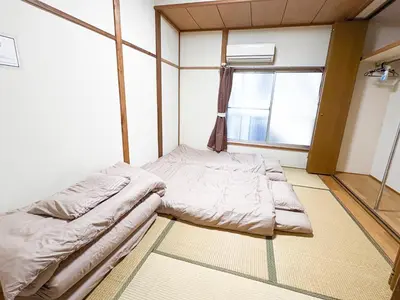a bed in a room with a window at Asakusa Hub Stay in Tokyo