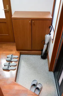 a group of shoes sitting on the floor in a room at Asakusa Hub Stay in Tokyo
