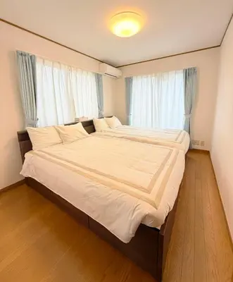 a large bed in a room with windows at Hotel Hanamichi in Tokyo