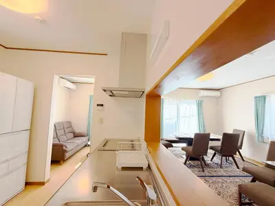 a kitchen and living room with a couch and a table at Hotel Hanamichi in Tokyo