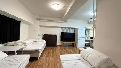 a room with two beds and a flat screen tv at Skytree\u5730\u9435\u5f92\u6b655\u5206 4\u5957\u885b\u6d74 4\u5957\u623f \u6d17\u8863\u6a5f \u6709\u96fb\u68af \u9802\u6a13\u6771\u4eac\u6674\u7a7a\u5854\u591c\u666f \u76f4\u9054\u8868\u53c3\u9053V444 in Tokyo