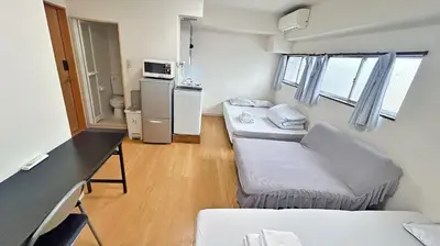 a small room with two couches and a kitchen at Tokyo\u591c\u666f 8\u5957\u885b\u6d74 8\u9593\u5957\u623f Skytree\u5730\u9435\u5f92\u6b655\u5206 \u6a5f\u5834\u76f4\u9054 \u6d17\u8863\u6a5f \u96fb\u68af 2\u5c64 in Tokyo