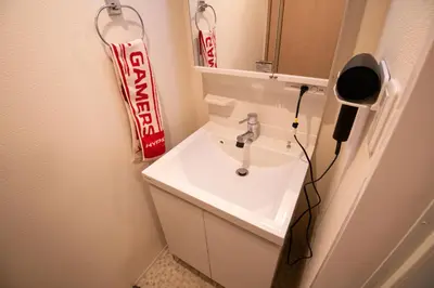 a bathroom with a white sink and a mirror at Elle Maison\u5927\u68ee 203 in Tokyo