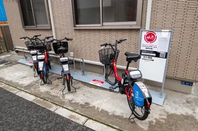 a row of bikes parked next to a building at Elle Maison\u5927\u68ee 203 in Tokyo