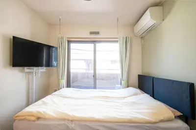 a bedroom with a bed with a large window at Elle Maison\u5927\u68ee 203 in Tokyo