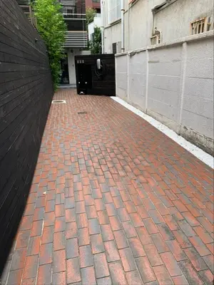 a brick walkway in a city with a building at Aoyama Roppongi Fully renovated Japanese house in Tokyo