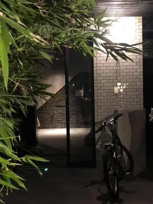 a bike parked in front of a glass doorway at Aoyama Roppongi Fully renovated Japanese house in Tokyo