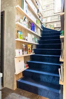 a stairway with blue steps in a bookstore at Aoyama Roppongi Fully renovated Japanese house in Tokyo